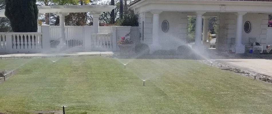 Sprinkler irrigation watering a lawn in Encinitas, CA.